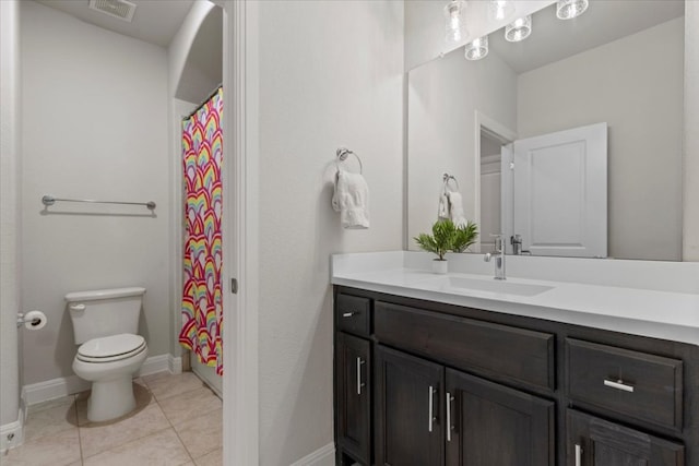 bathroom featuring visible vents, toilet, vanity, tile patterned flooring, and baseboards