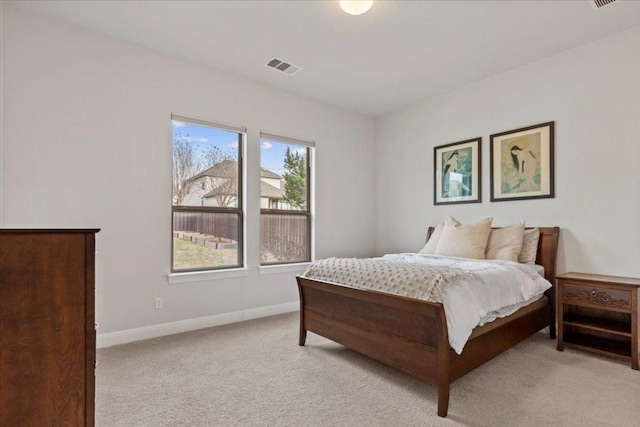 bedroom featuring light carpet, visible vents, and baseboards