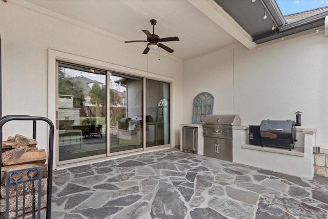 view of patio / terrace featuring ceiling fan, an outdoor kitchen, and grilling area