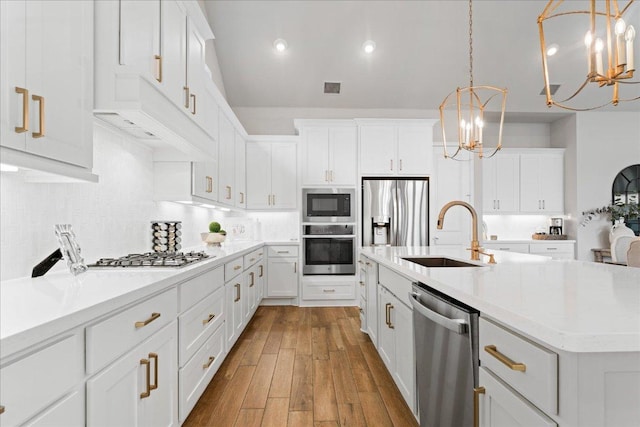 kitchen with stainless steel appliances, a sink, visible vents, and white cabinetry