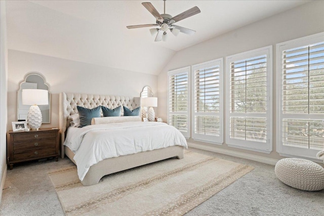 carpeted bedroom featuring a ceiling fan, vaulted ceiling, and baseboards