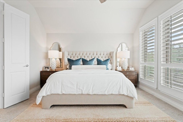 bedroom with vaulted ceiling, carpet flooring, a ceiling fan, and baseboards