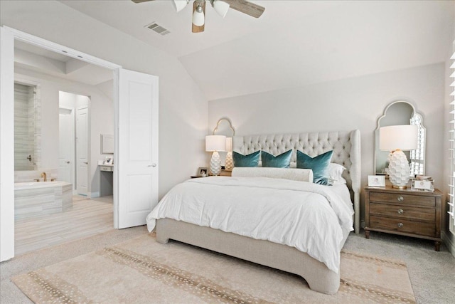 bedroom featuring lofted ceiling, ensuite bath, visible vents, and ceiling fan