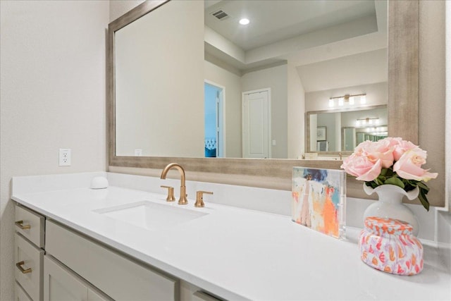 bathroom with recessed lighting, visible vents, and vanity