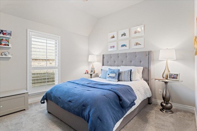 bedroom with vaulted ceiling, carpet flooring, and baseboards