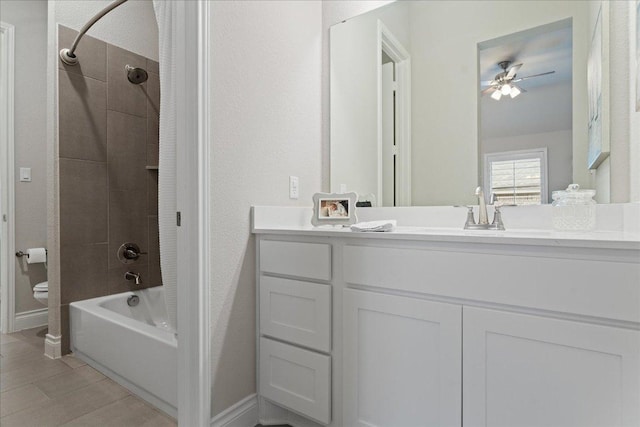 full bath with bathing tub / shower combination, vanity, toilet, and baseboards