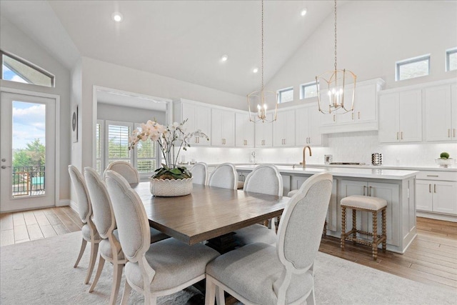 dining room featuring light wood-type flooring, high vaulted ceiling, and recessed lighting