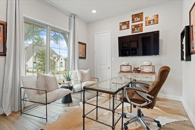 living area with recessed lighting, wood finished floors, and baseboards