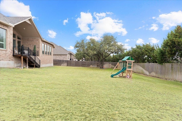 view of yard featuring a playground and a fenced backyard