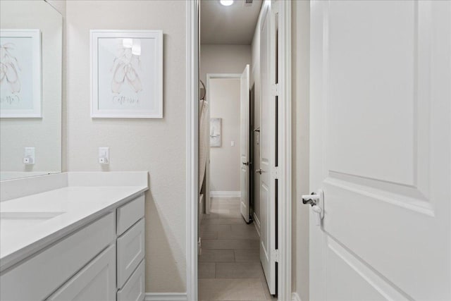 bathroom with a shower with curtain, tile patterned flooring, and vanity