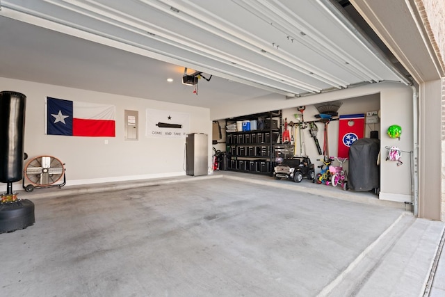 garage with baseboards and a garage door opener