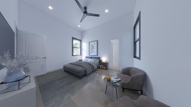 bedroom featuring recessed lighting, a towering ceiling, a ceiling fan, wood finished floors, and baseboards