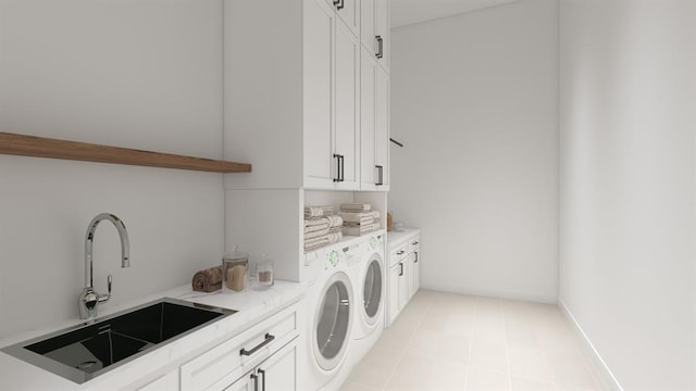 washroom featuring light tile patterned floors, a sink, baseboards, cabinet space, and washer and clothes dryer