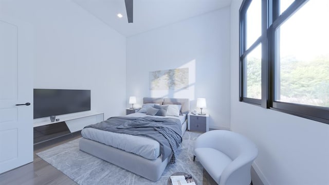 bedroom featuring multiple windows and wood finished floors