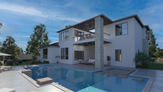 back of property with an in ground hot tub, a patio area, a balcony, and stucco siding