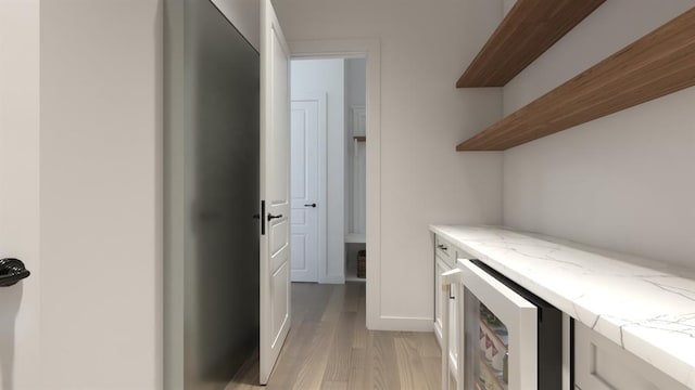 interior space with light wood-style floors and wine cooler