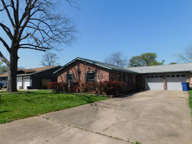 ranch-style home with a garage, driveway, a front lawn, and brick siding