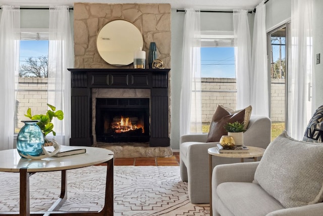 living area with a wealth of natural light and a fireplace