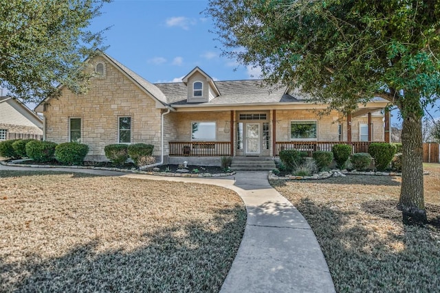 view of front facade with stone siding and a porch