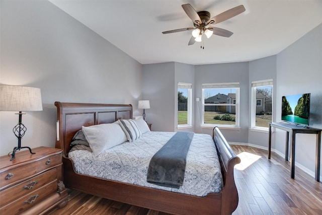 bedroom with ceiling fan, baseboards, and wood finished floors