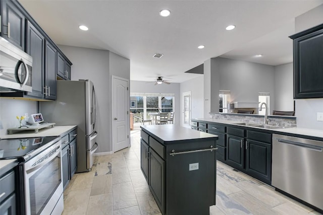 kitchen featuring a sink, visible vents, light countertops, appliances with stainless steel finishes, and a center island