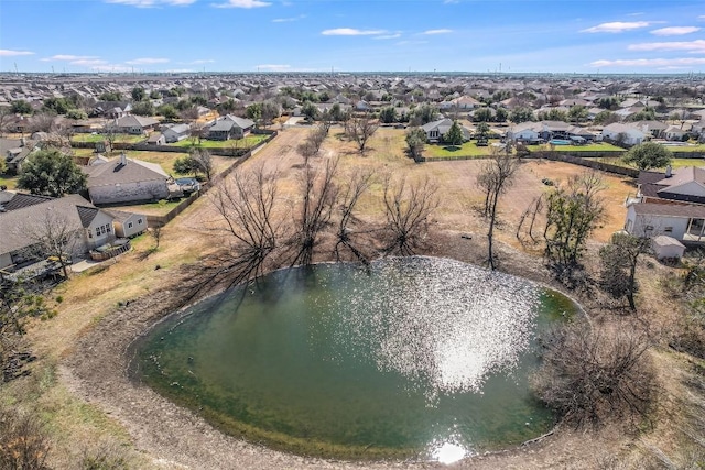 birds eye view of property with a water view and a residential view