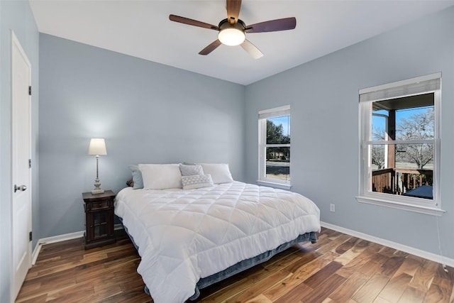 bedroom with a ceiling fan, baseboards, and wood finished floors