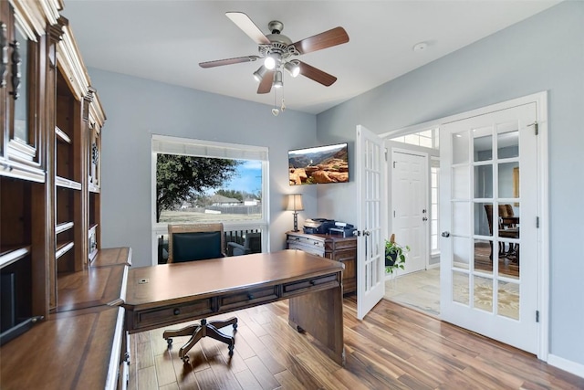 office space with ceiling fan, french doors, wood finished floors, and baseboards