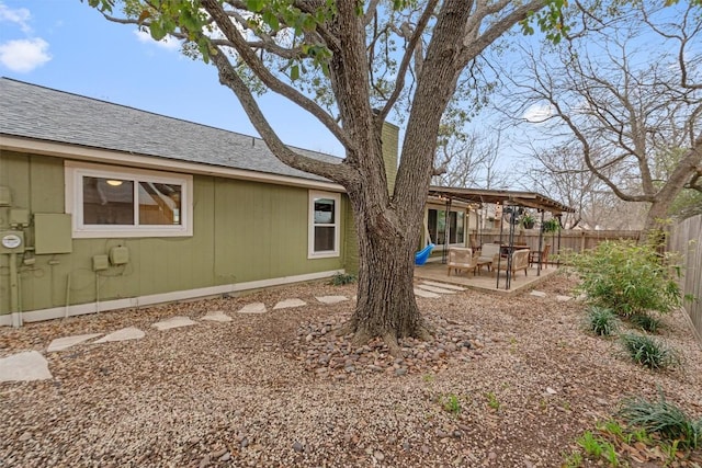 view of yard featuring fence and a patio