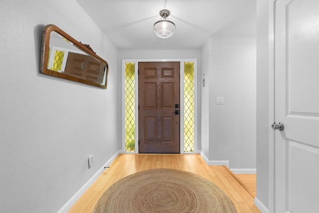 entrance foyer with light wood-type flooring and baseboards