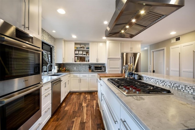 kitchen featuring premium range hood, a sink, visible vents, appliances with stainless steel finishes, and open shelves