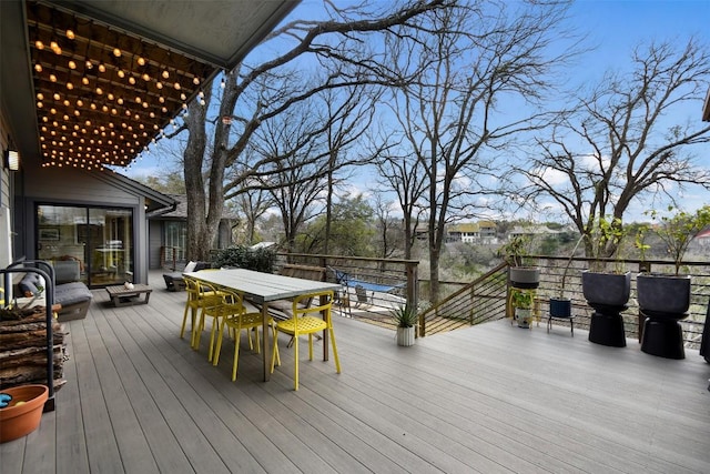 wooden terrace with outdoor dining area