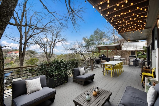 wooden terrace featuring outdoor dining space, a grill, and area for grilling