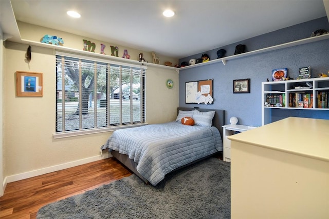 bedroom with recessed lighting, baseboards, and wood finished floors