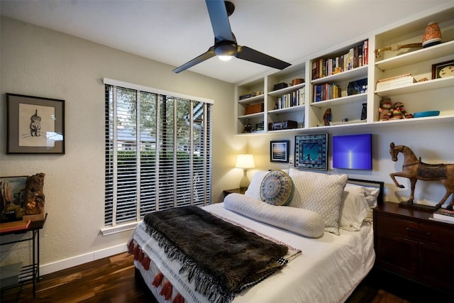 bedroom with a textured wall, ceiling fan, baseboards, and wood finished floors