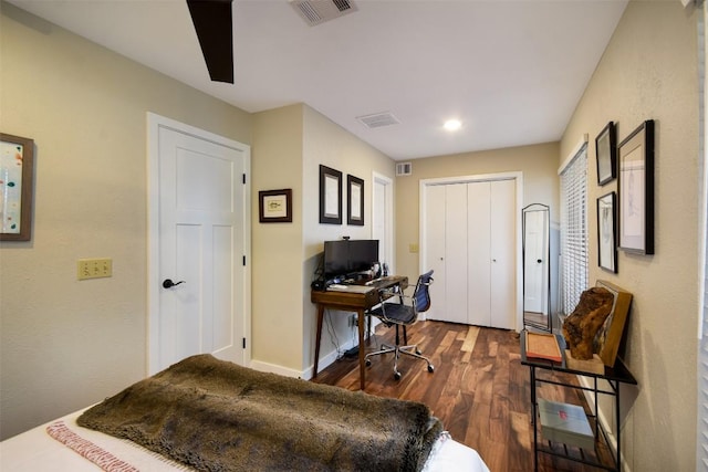 home office with dark wood-style floors, baseboards, and visible vents