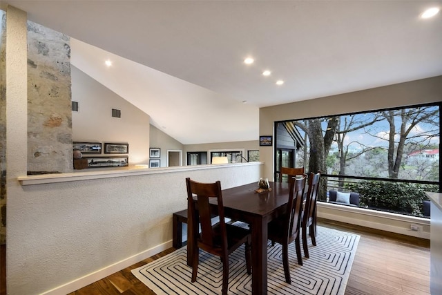 dining space featuring visible vents, baseboards, wood finished floors, vaulted ceiling, and recessed lighting