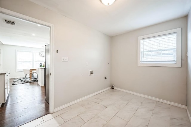 washroom with washer hookup, marble finish floor, hookup for an electric dryer, laundry area, and baseboards