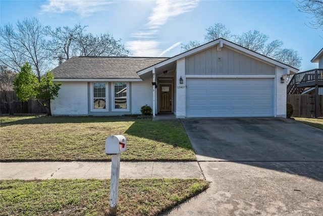 view of front of house with a garage, concrete driveway, fence, a front lawn, and brick siding