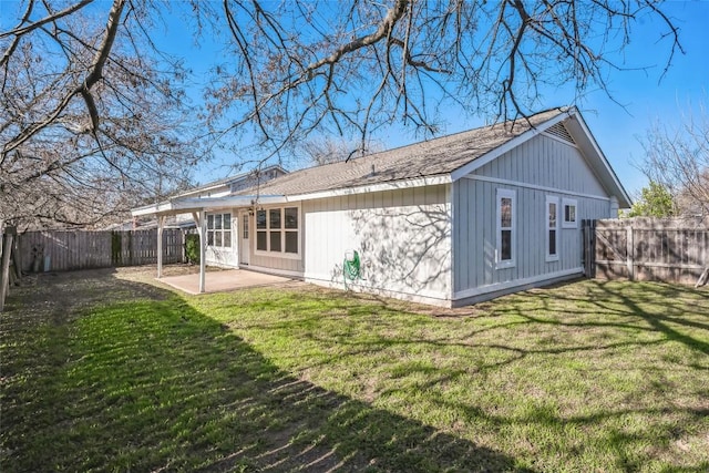 back of property with a yard, a fenced backyard, and a patio