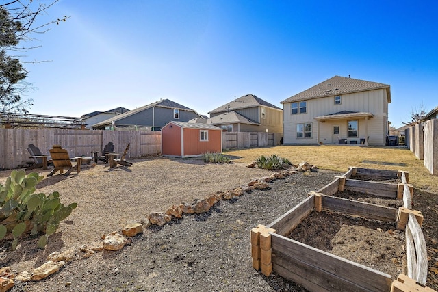 217 Bonnet Blvd, Georgetown, TX 78628 - fenced backyard featuring an outdoor fire pit and a vegetable garden
