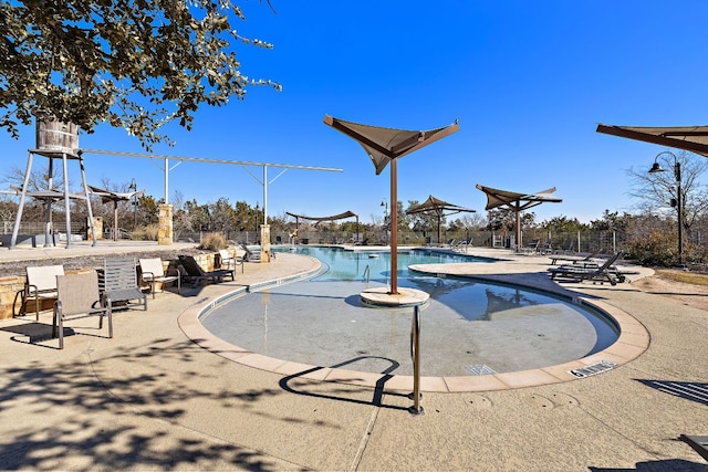 pool featuring a patio area and fence