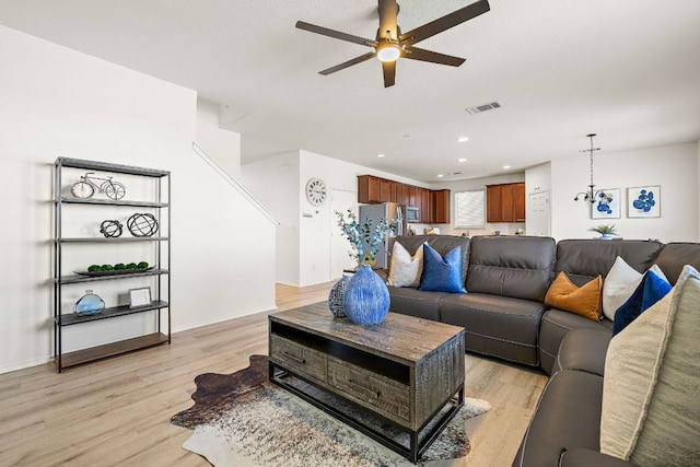 living room featuring light wood finished floors, recessed lighting, visible vents, a ceiling fan, and baseboards