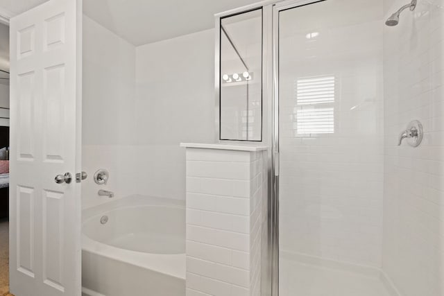 ensuite bathroom featuring a stall shower, a garden tub, and ensuite bathroom