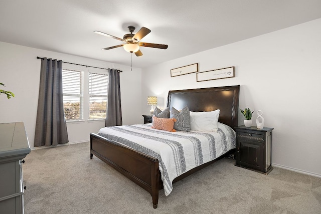 bedroom with light carpet, ceiling fan, and baseboards