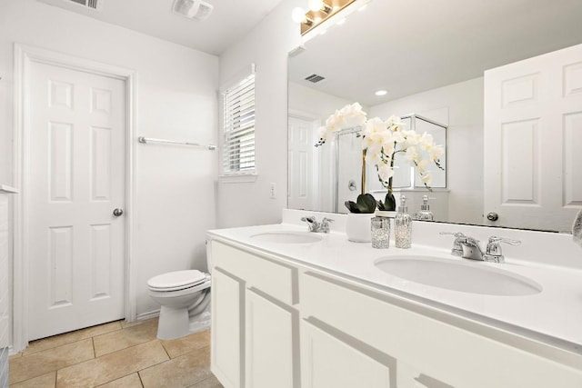 full bathroom with toilet, a sink, and visible vents