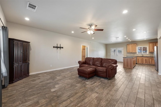 living area featuring wood finished floors, visible vents, and recessed lighting