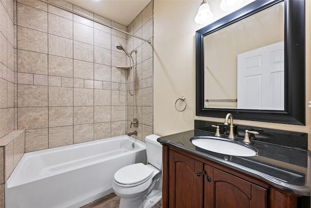 full bath with bathtub / shower combination, vanity, and toilet