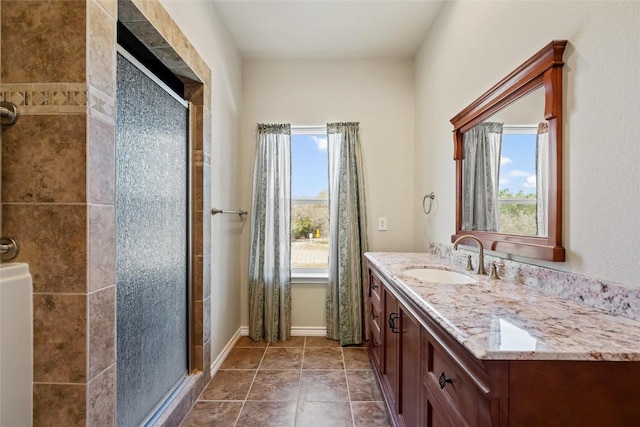 full bathroom featuring a stall shower, plenty of natural light, and vanity