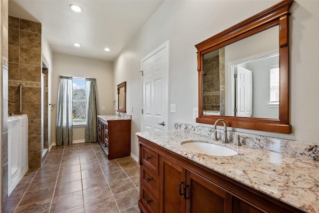 full bath with tile patterned flooring, two vanities, a sink, and a shower stall